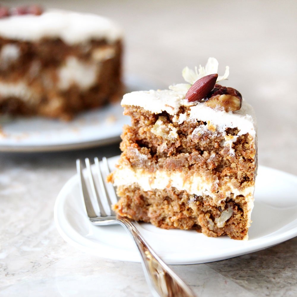 slice of paleo cauliflower carrot cake with frosting