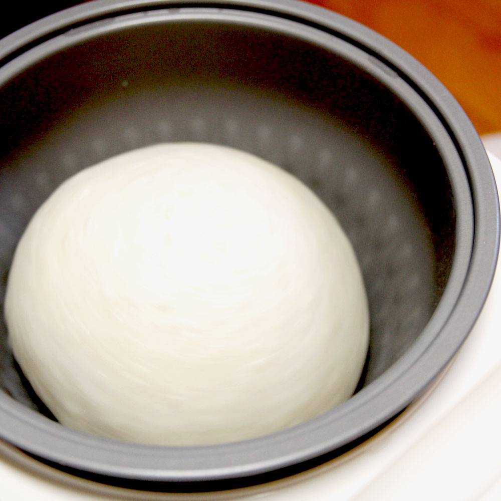 mochi maker pounding sweet white rice into mochi