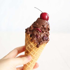 chocolate cherry nice cream on a waffle cone