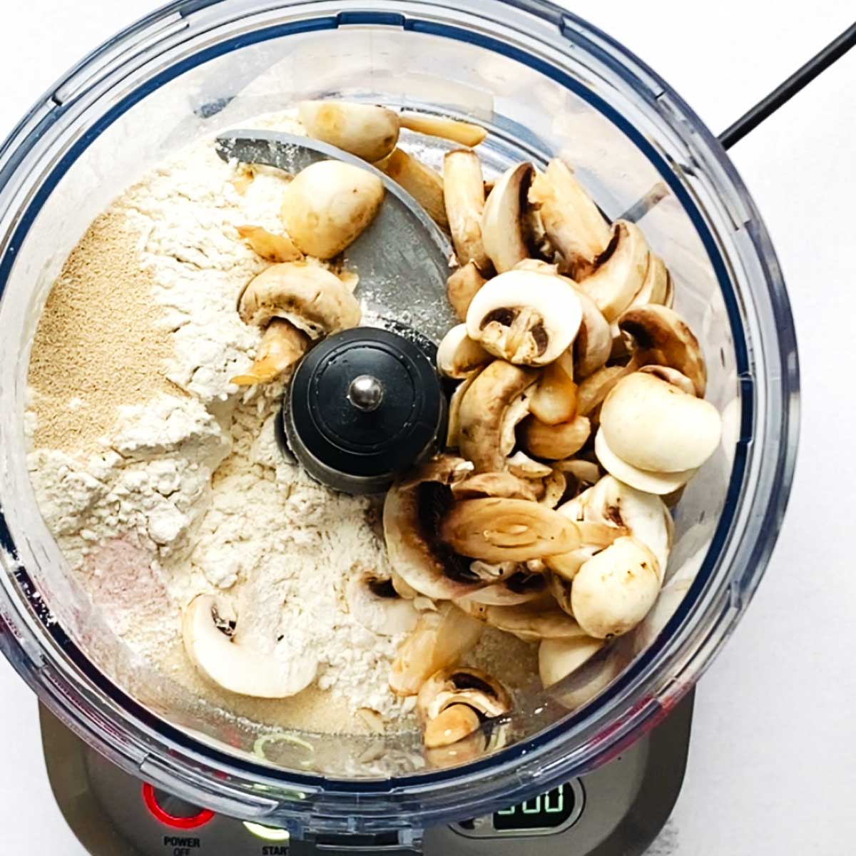 In a food processor, combine all dry ingredients: bread flour, yeast, sugar, salt. Add the cooked sliced mushrooms.